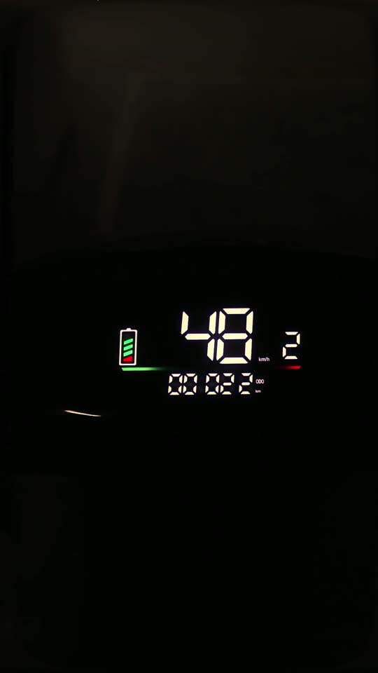 Glowing electric scooter speedometer at night