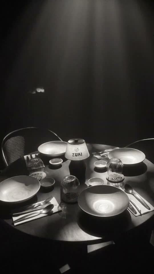 Black and white restaurant table under a beam of light